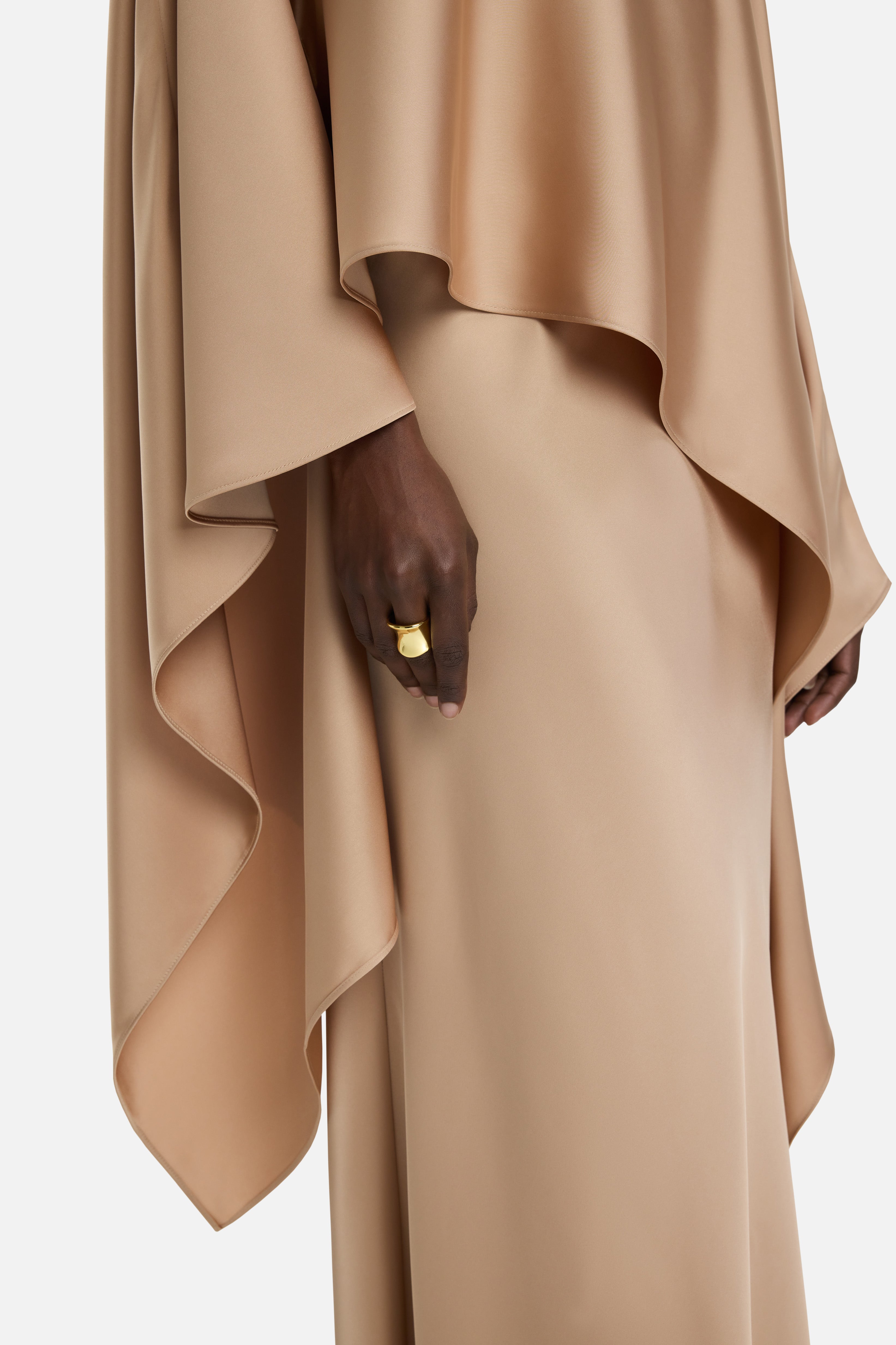 Detailed side view of light brown blouse