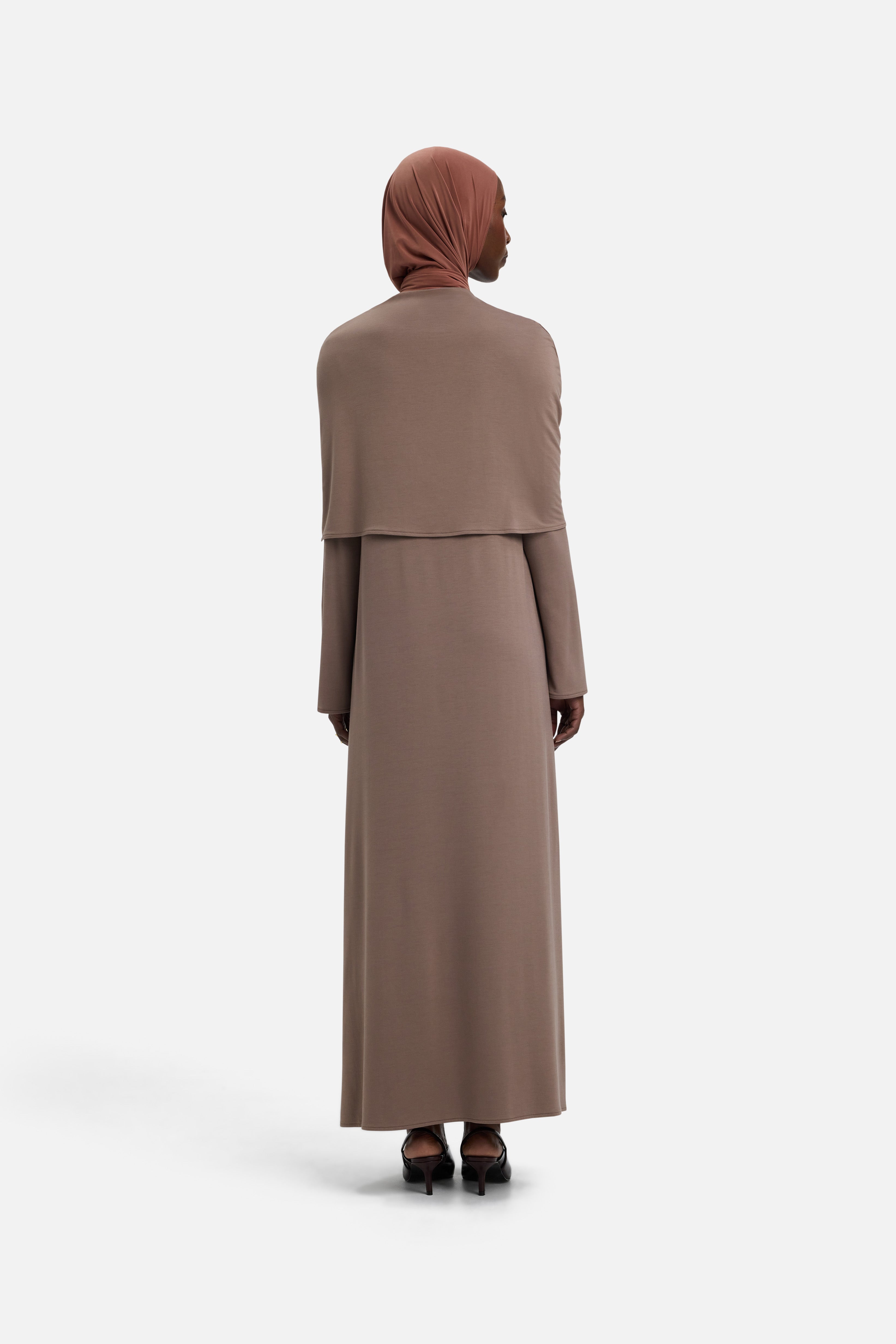 Back view model wearing taupe dress