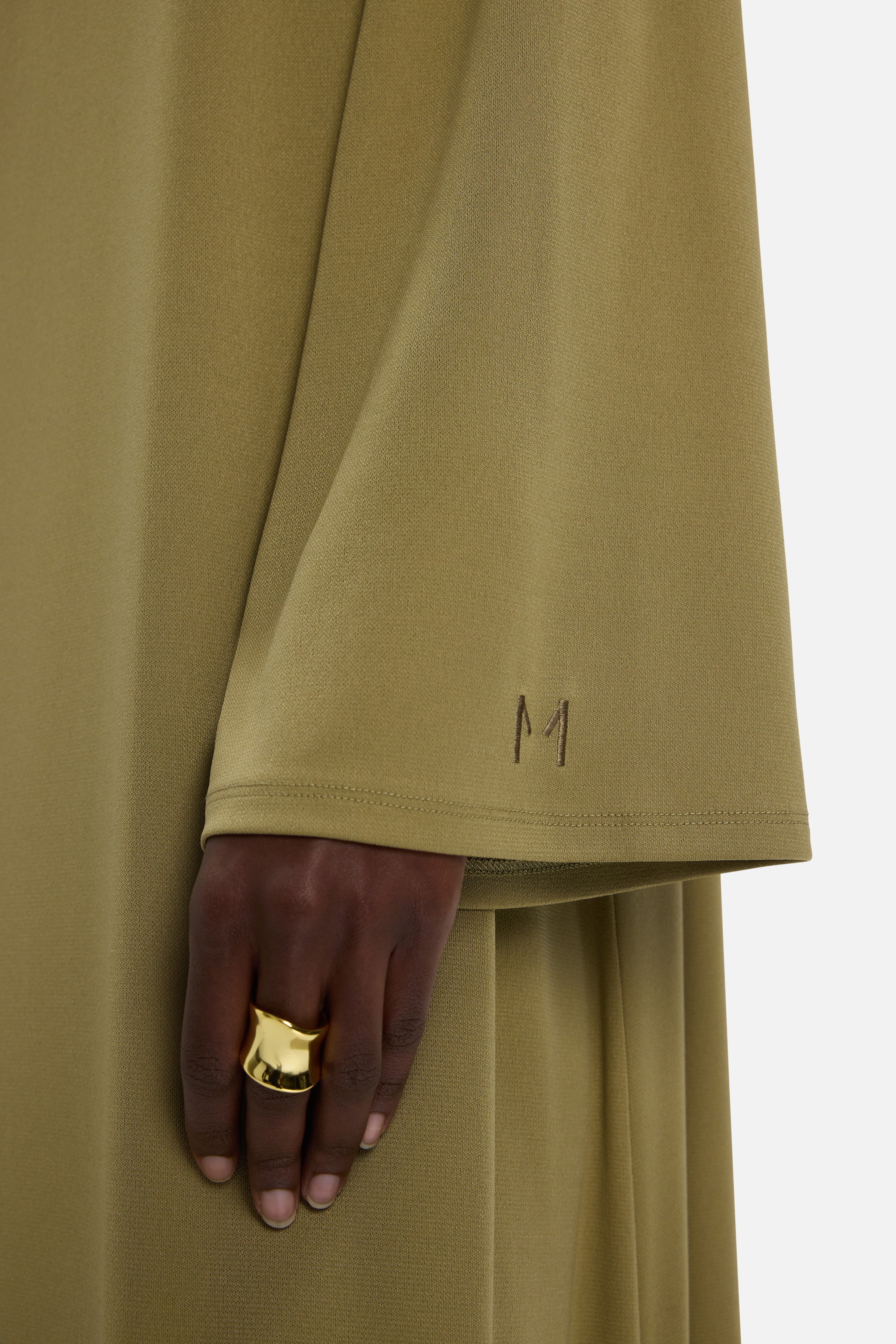 Sleeve detail on dress with MERRACHI logo