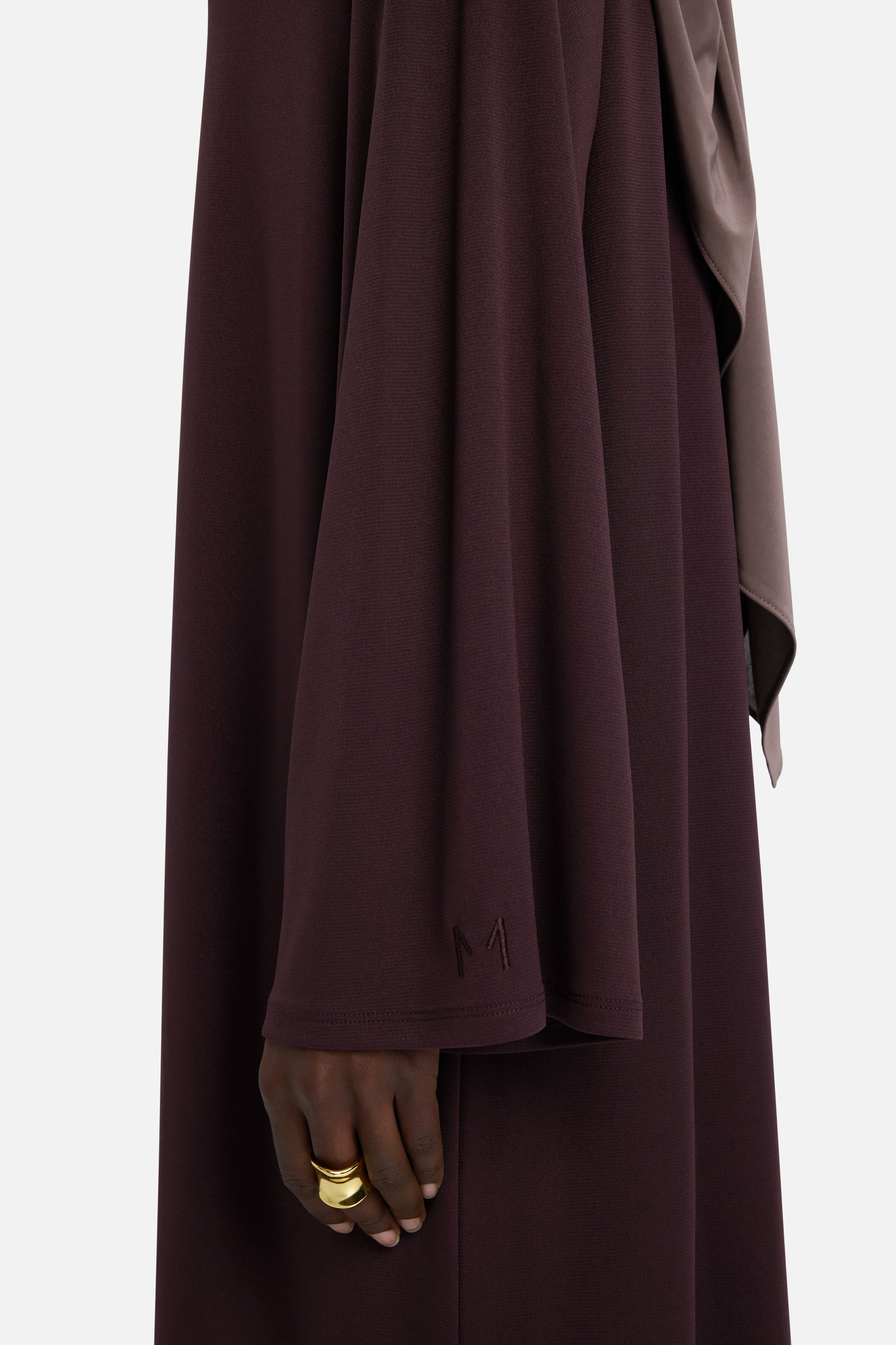 Sleeve detail MERRACHI logo on purple dress