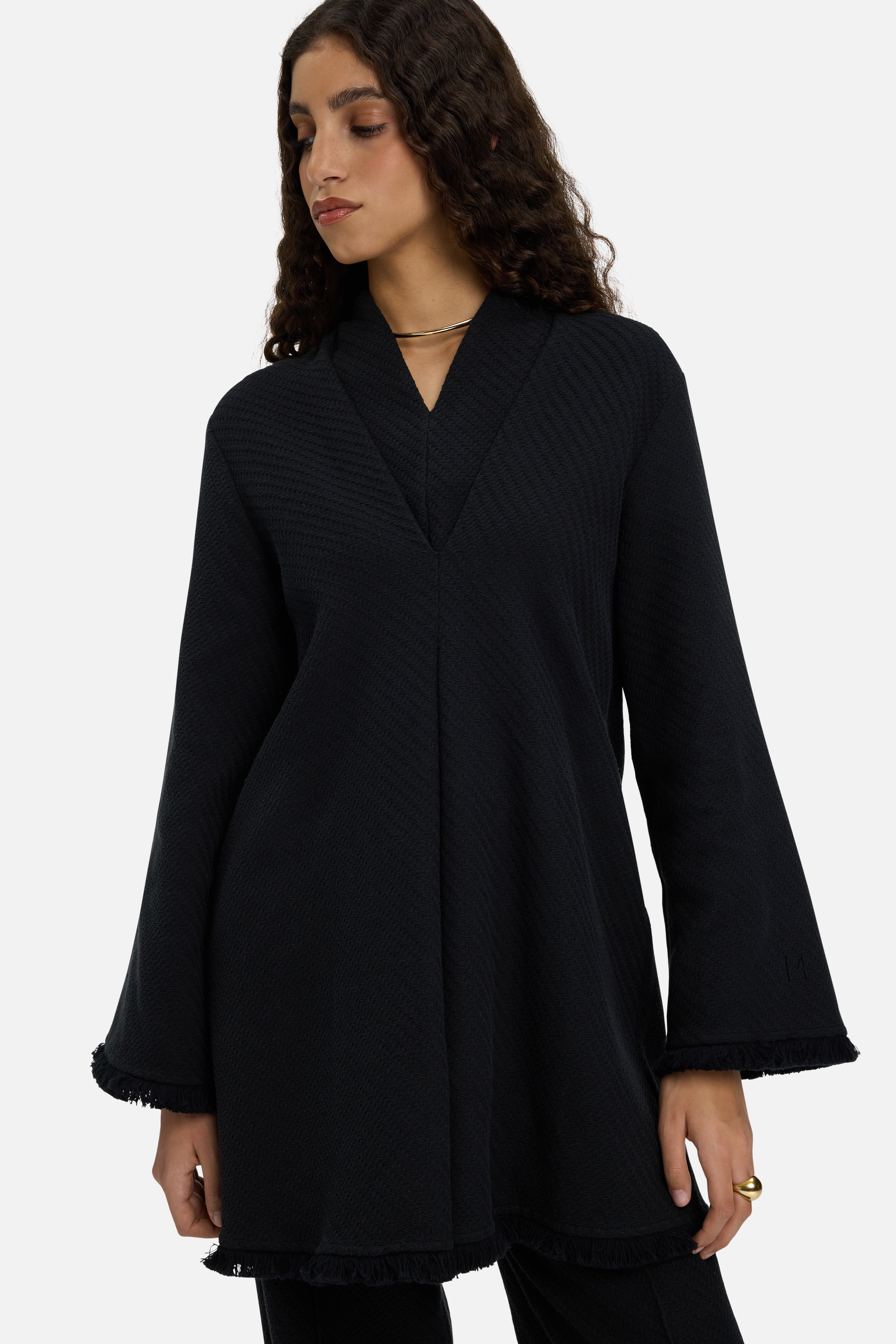 Detail shot model wearing long black top