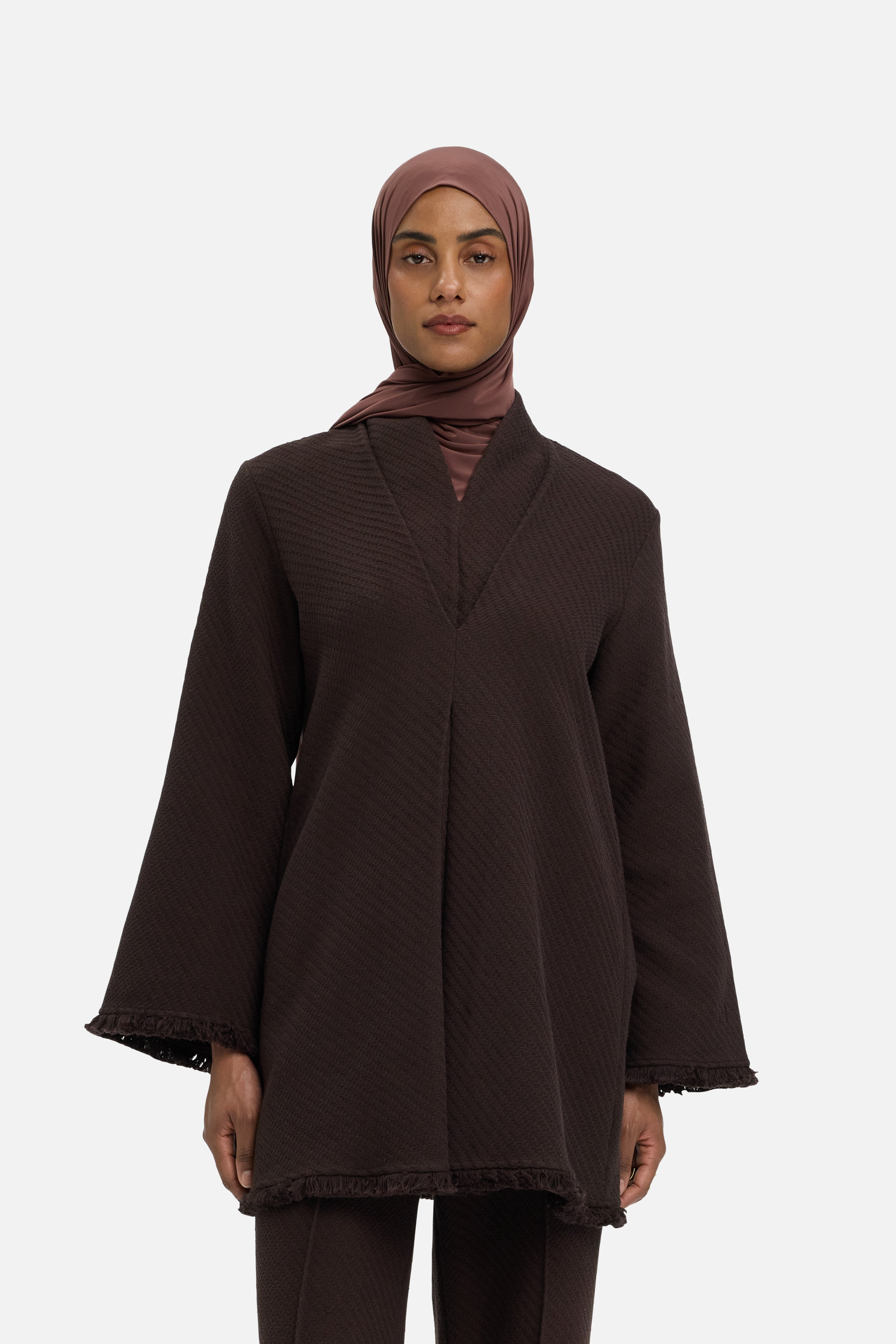 Cropped view model wearing brown top and headscarf