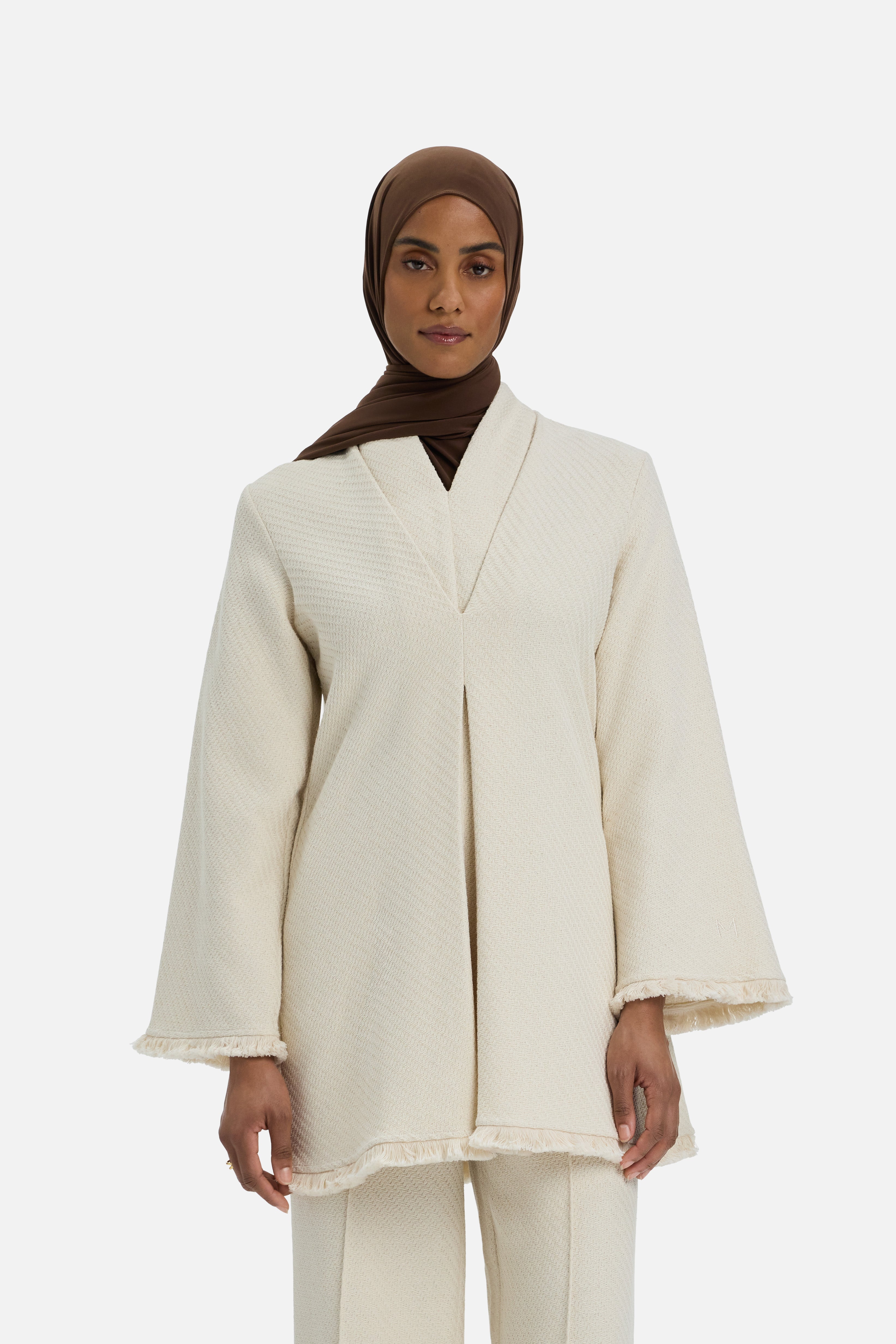 Cropped front view model wearing white top and brown headscarf