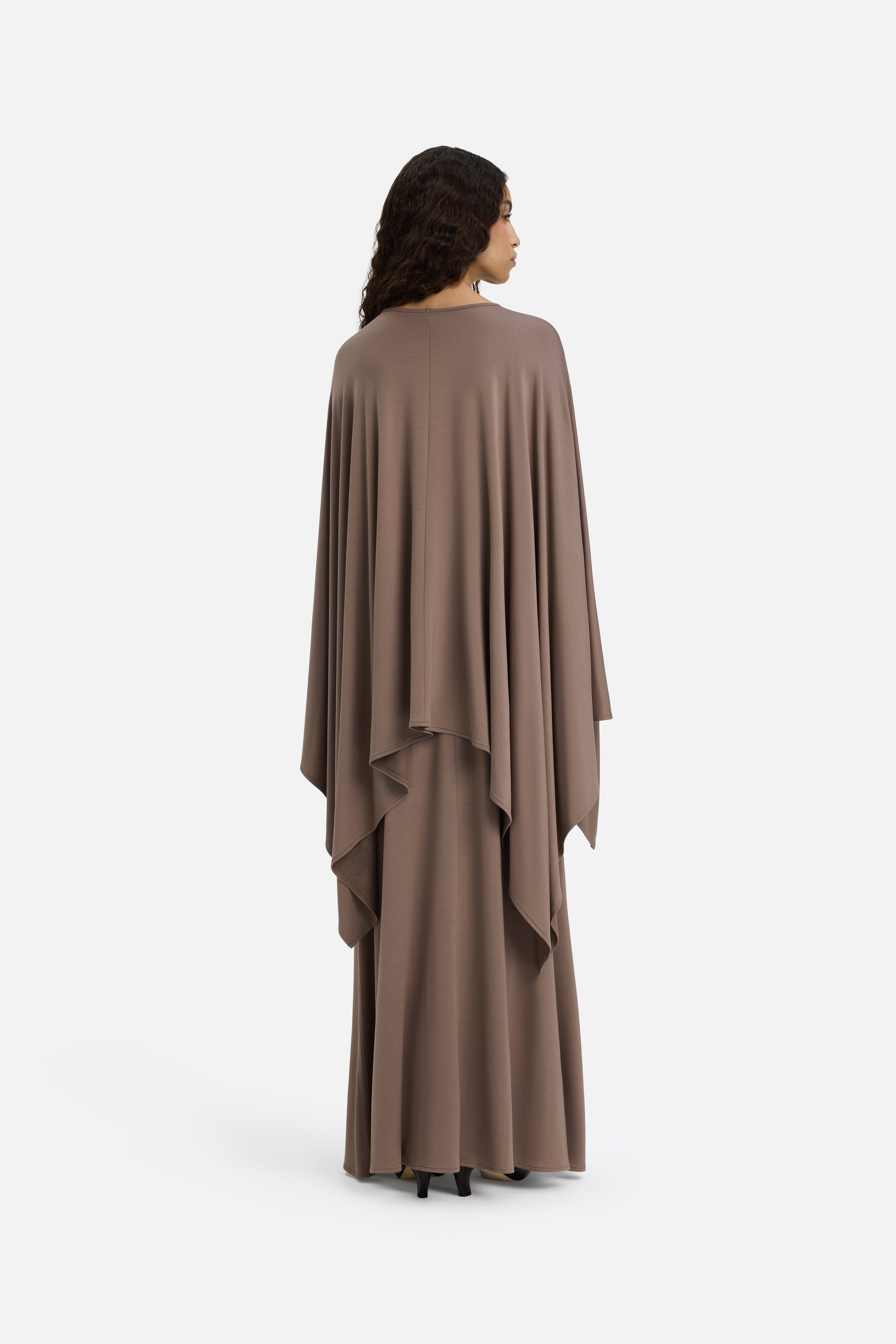 Back view model wearing taupe maxi skirt