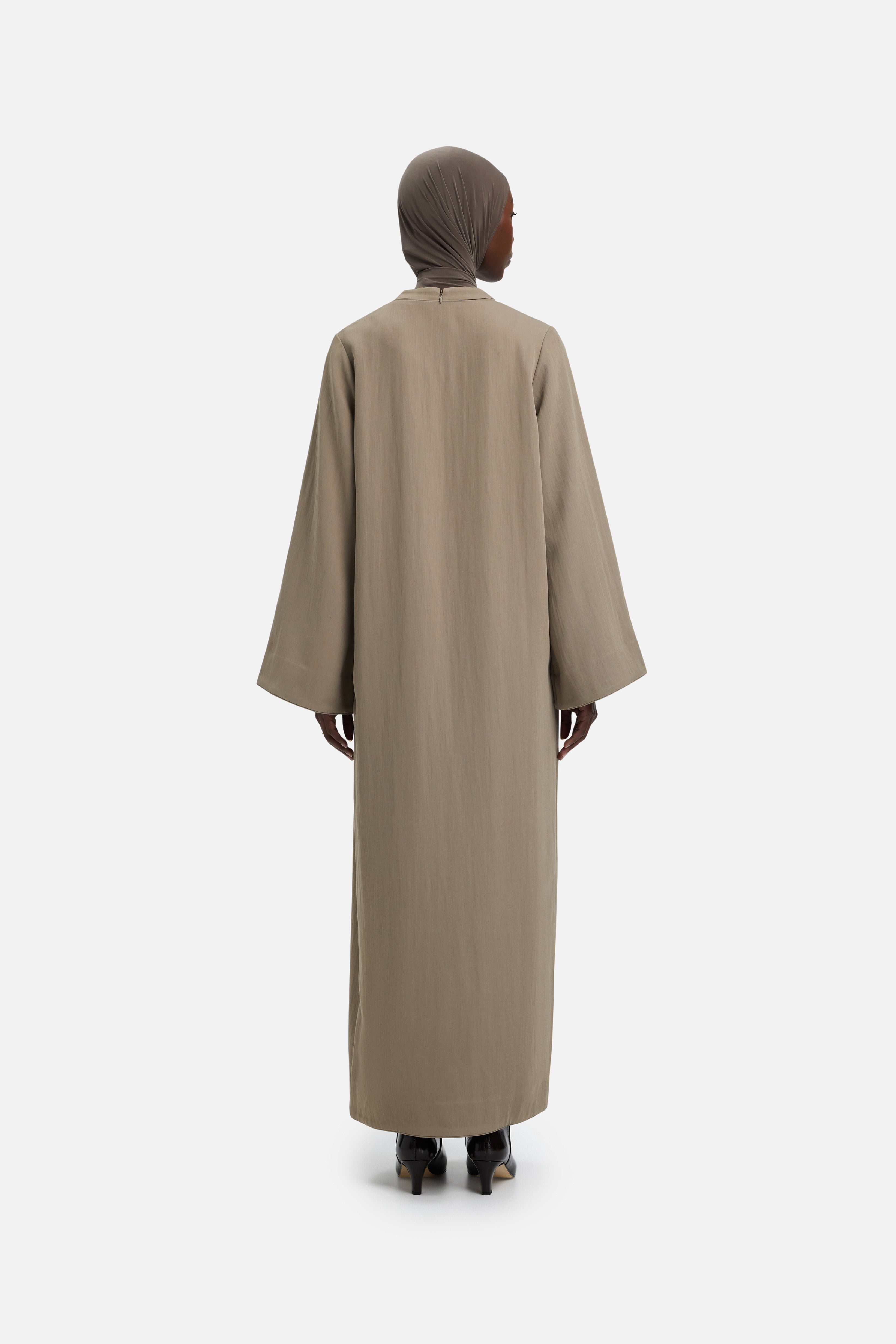 Back view model wearing khaki abaya and grey headscarf