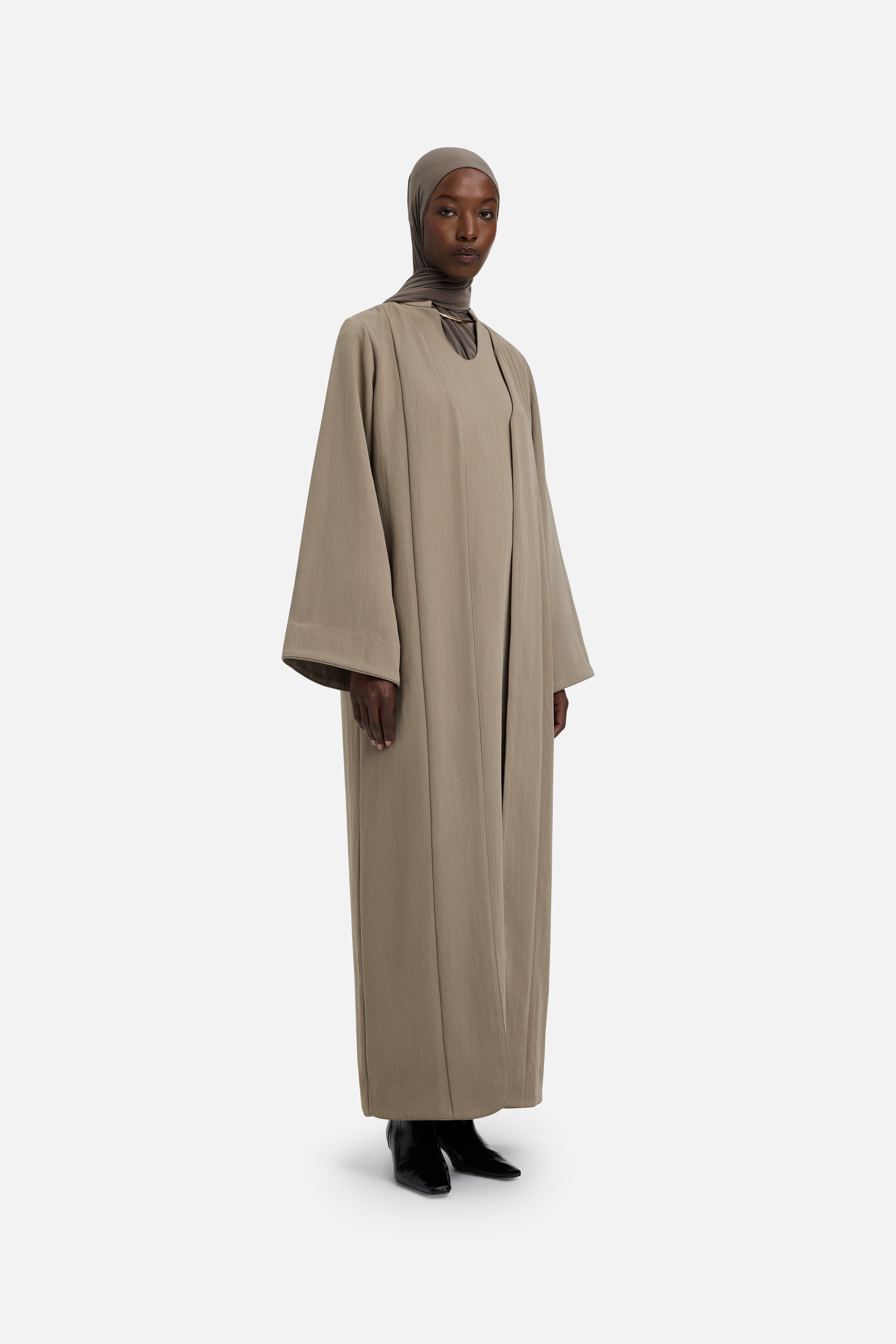 Side view model wearing khaki abaya and grey headscarf
