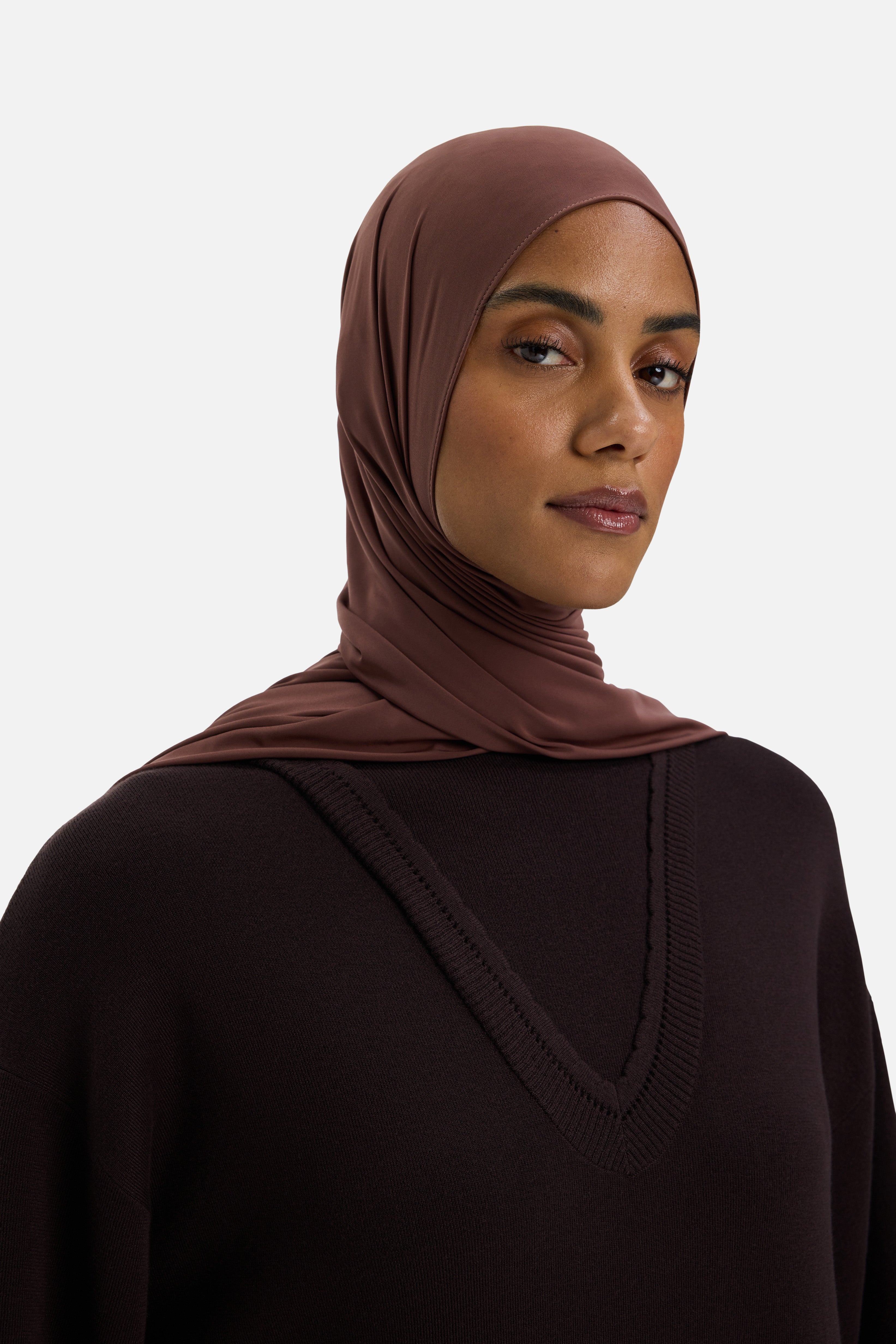Close up model wearing brown dress and headscarf
