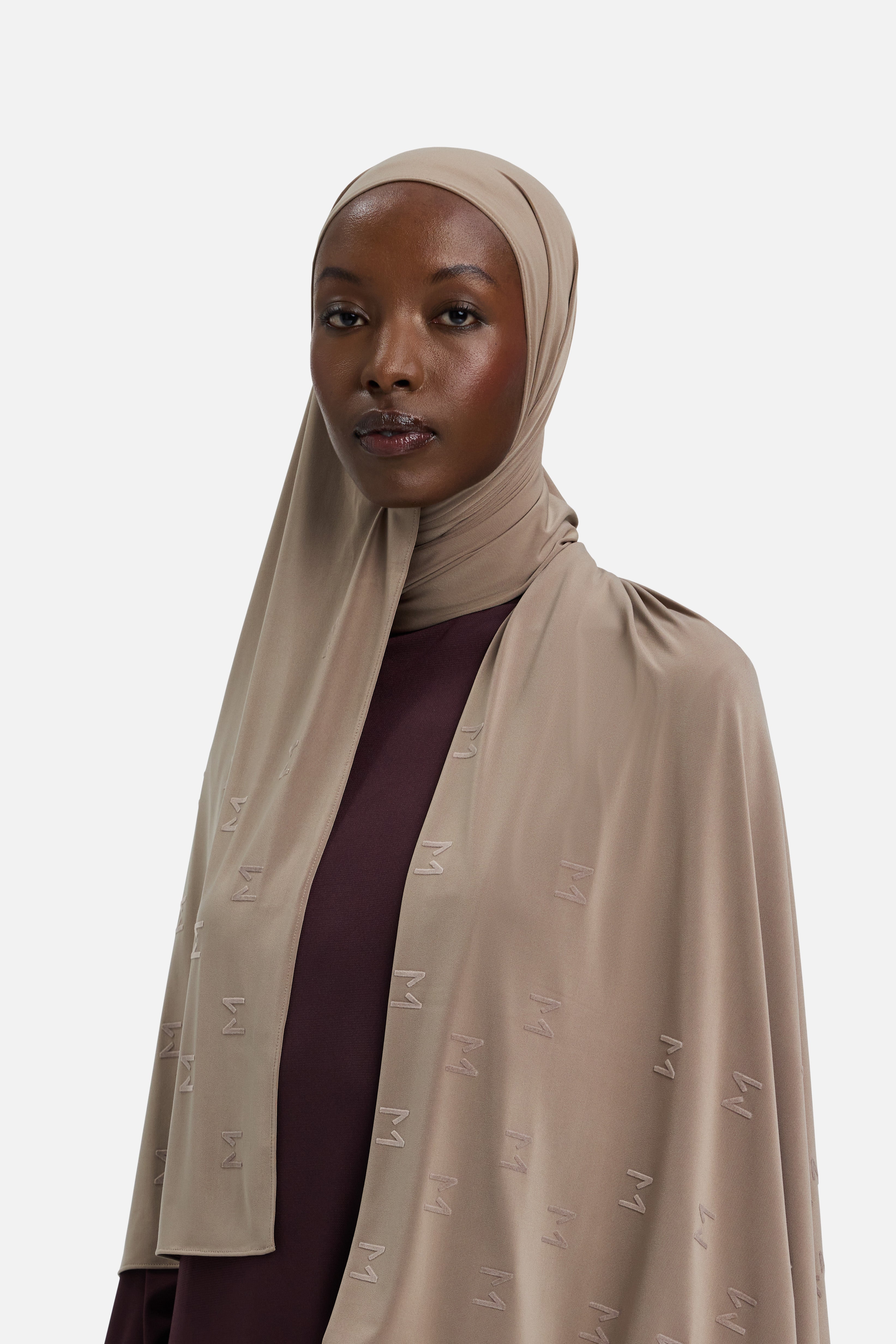 Model wearing taupe headscarf MERRACHI logo embroidery, side view