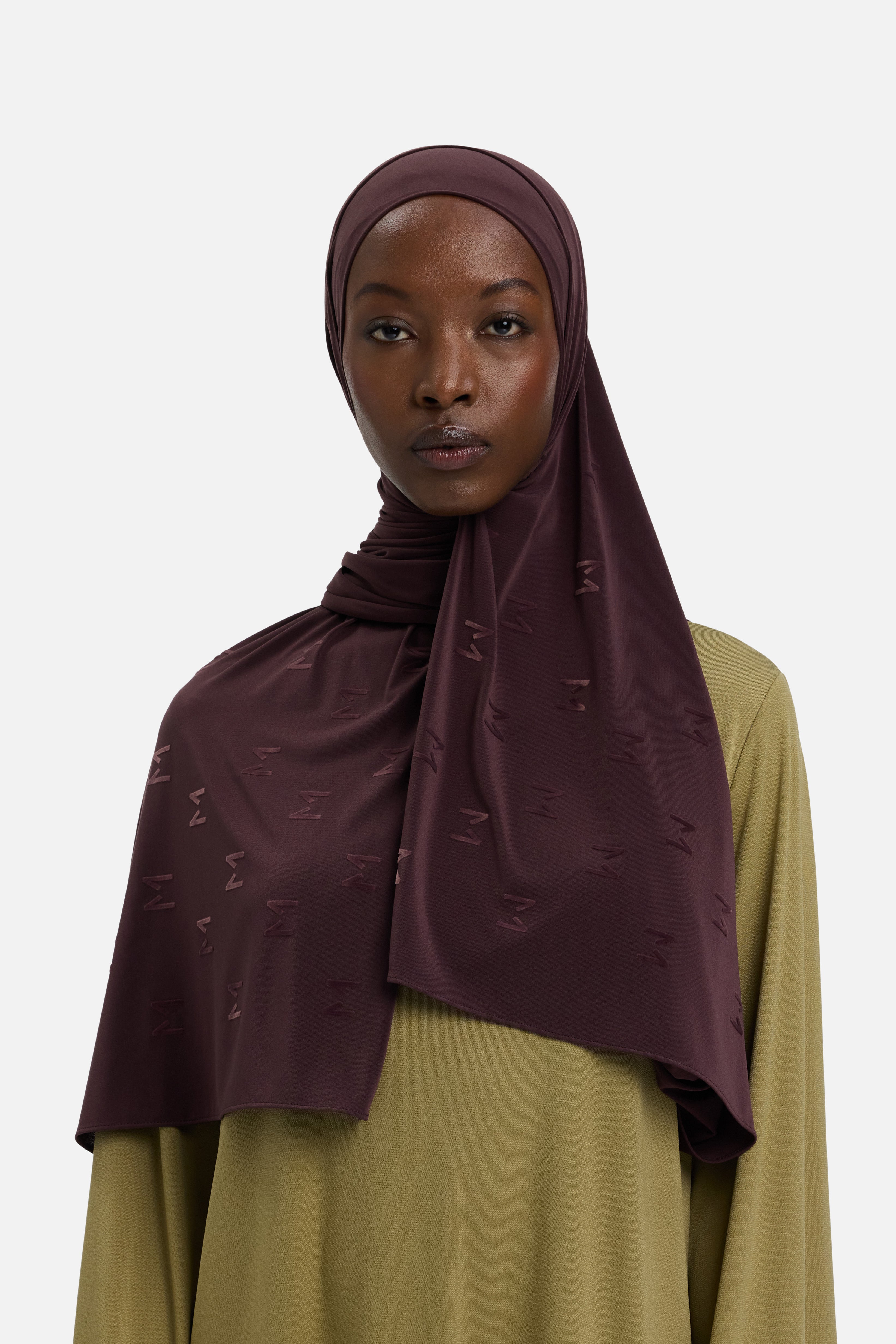 Model wearing purple headscarf MERRACHI logo embroidery, front view