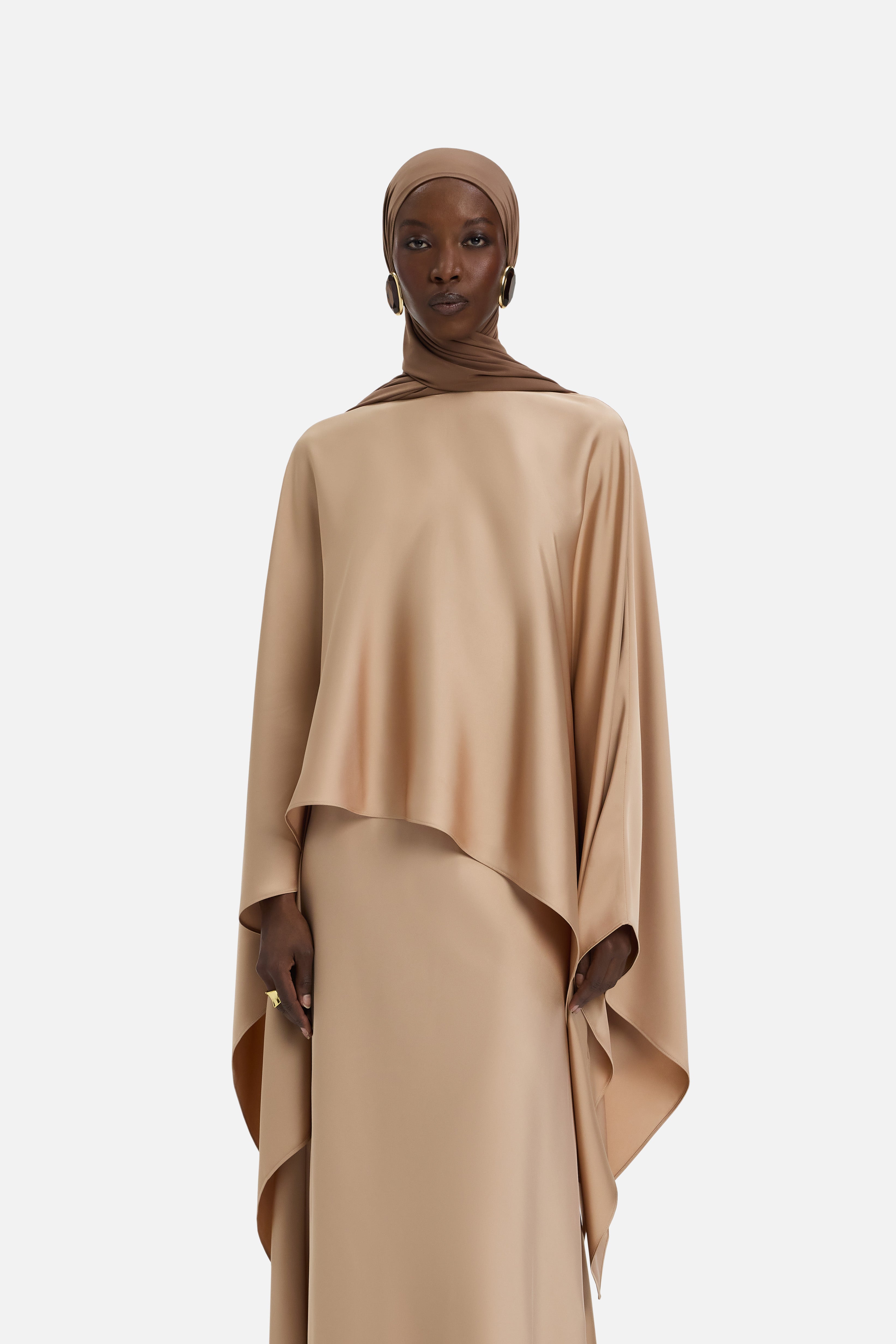 Cropped front view of model wearing light brown blouse