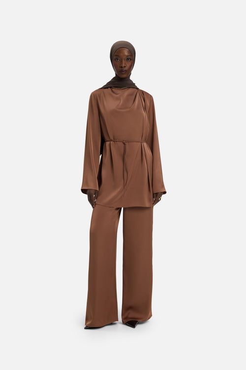 Front view model wearing bordeaux blouse