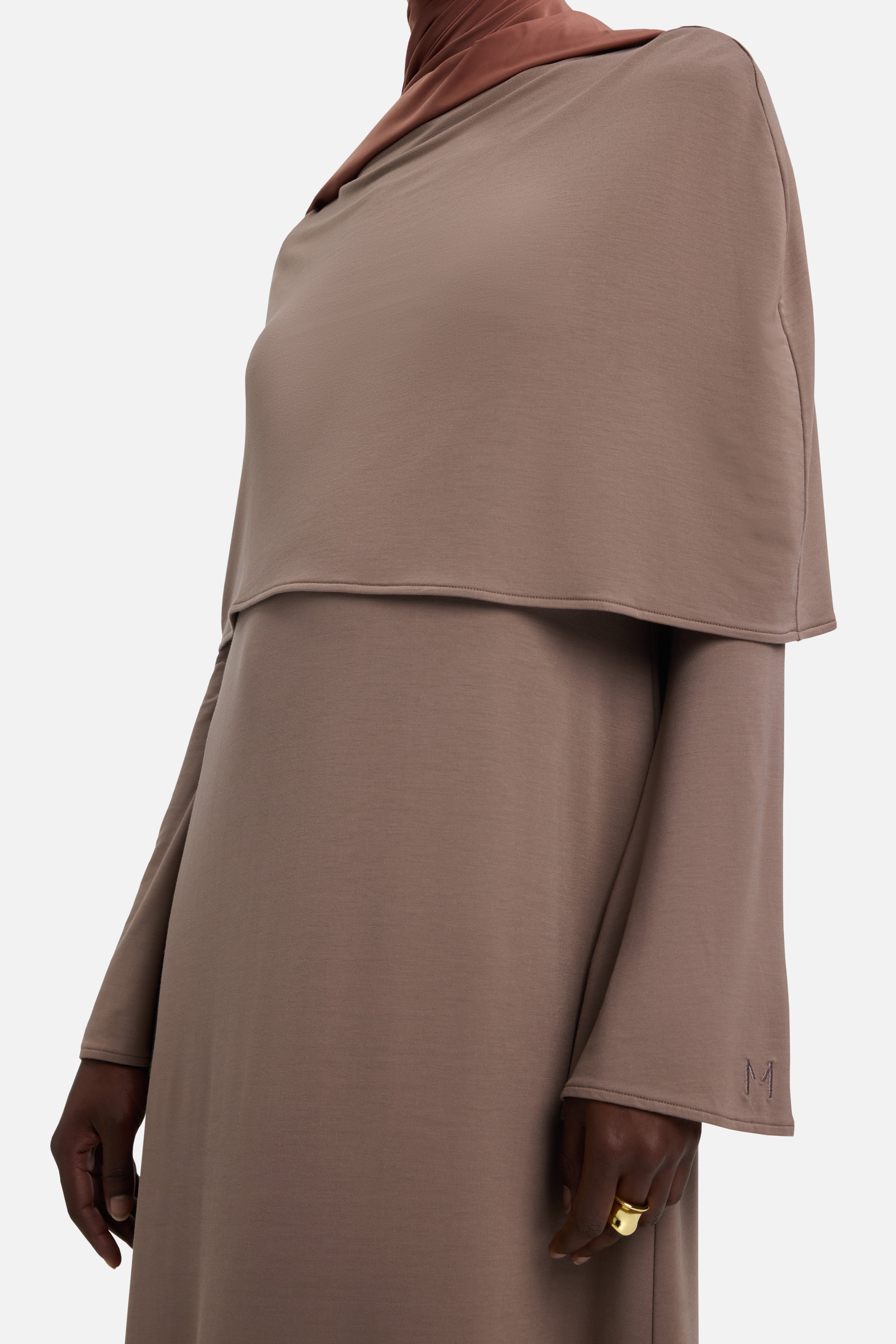 Detail shot model wearing taupe dress