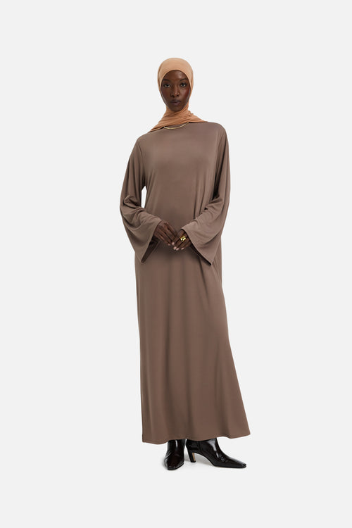Front view model wearing taupe dress and orange headscarf