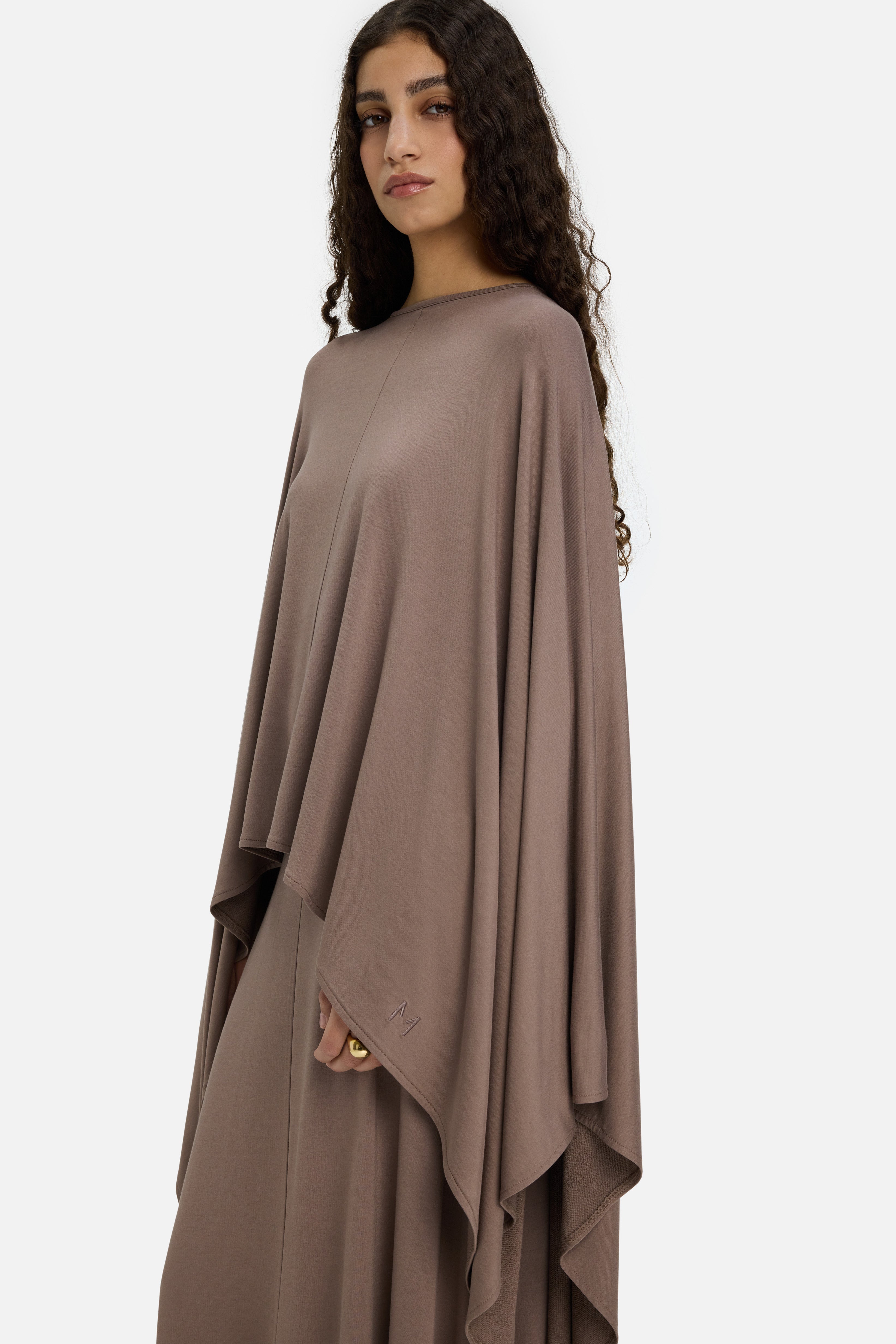 Model wearing taupe MERRACHI cape, cropped side view