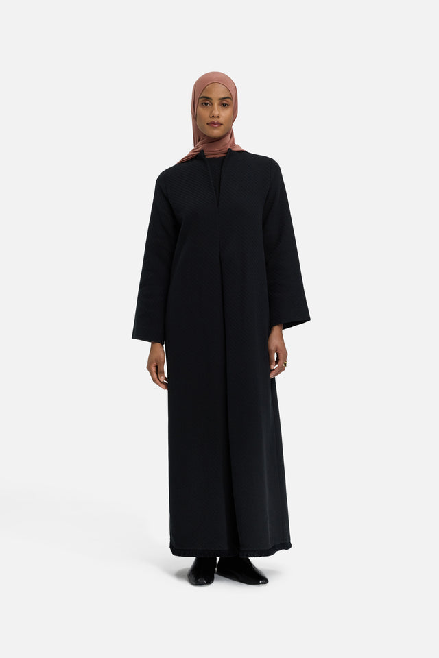 Front view model wearing black dress and pink headscarf