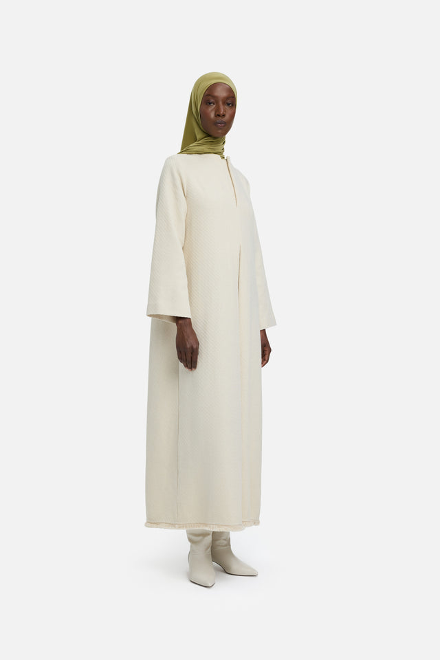Front view model wearing off white dress and green headscarf