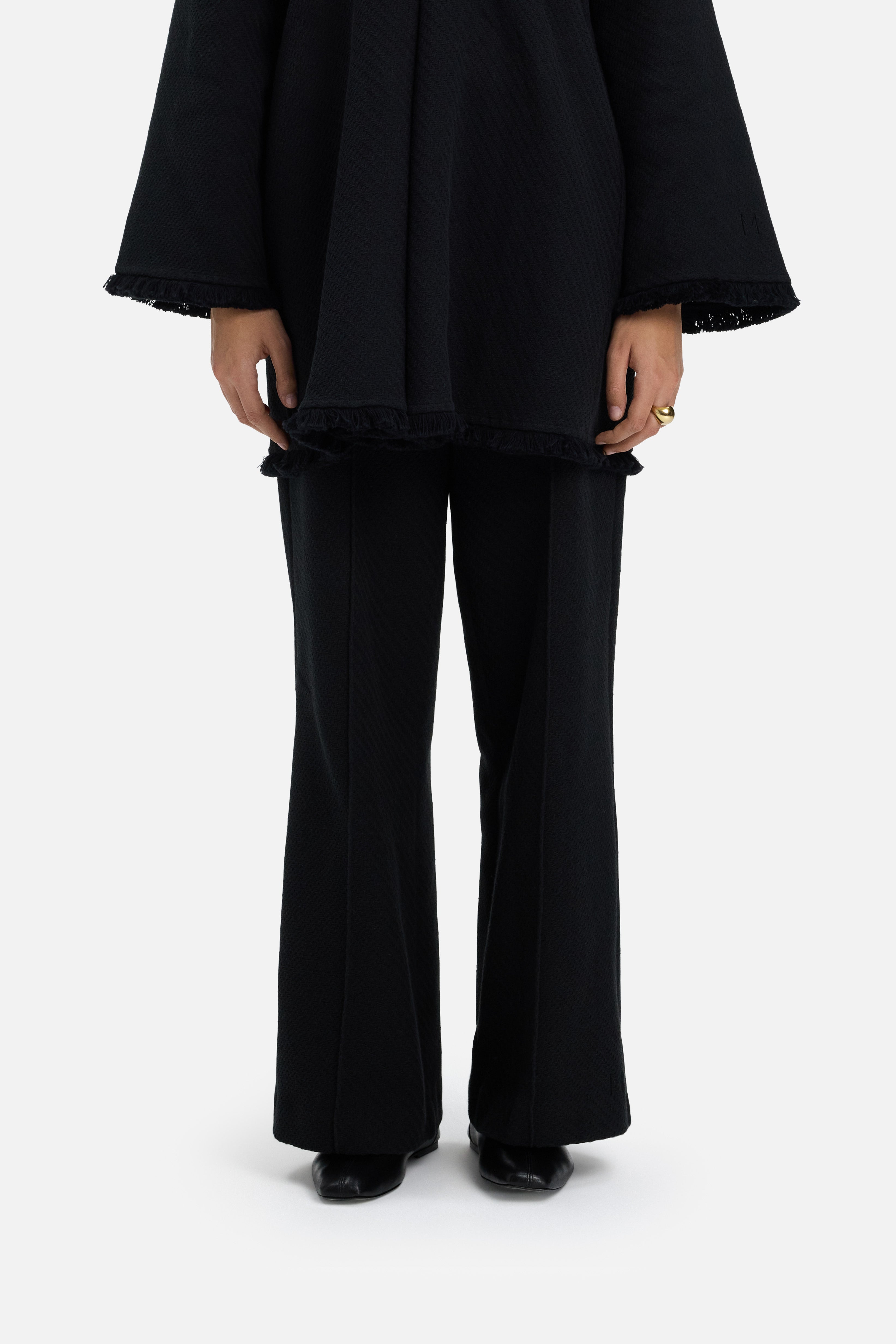 Detail shot model wearing black trousers