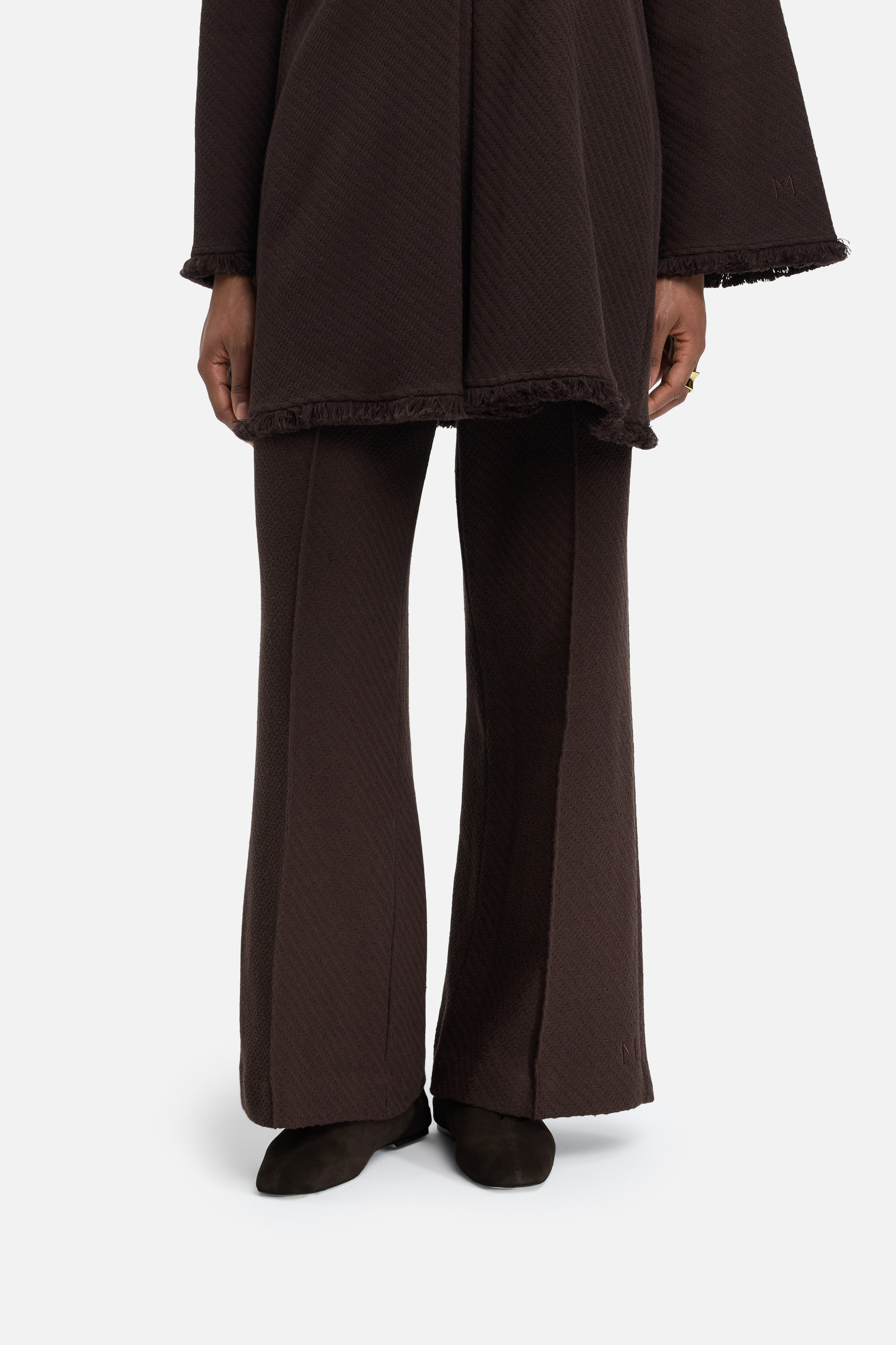 Cropped view model wearing brown pants 