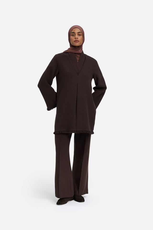 Front view model wearing brown pants and headscarf