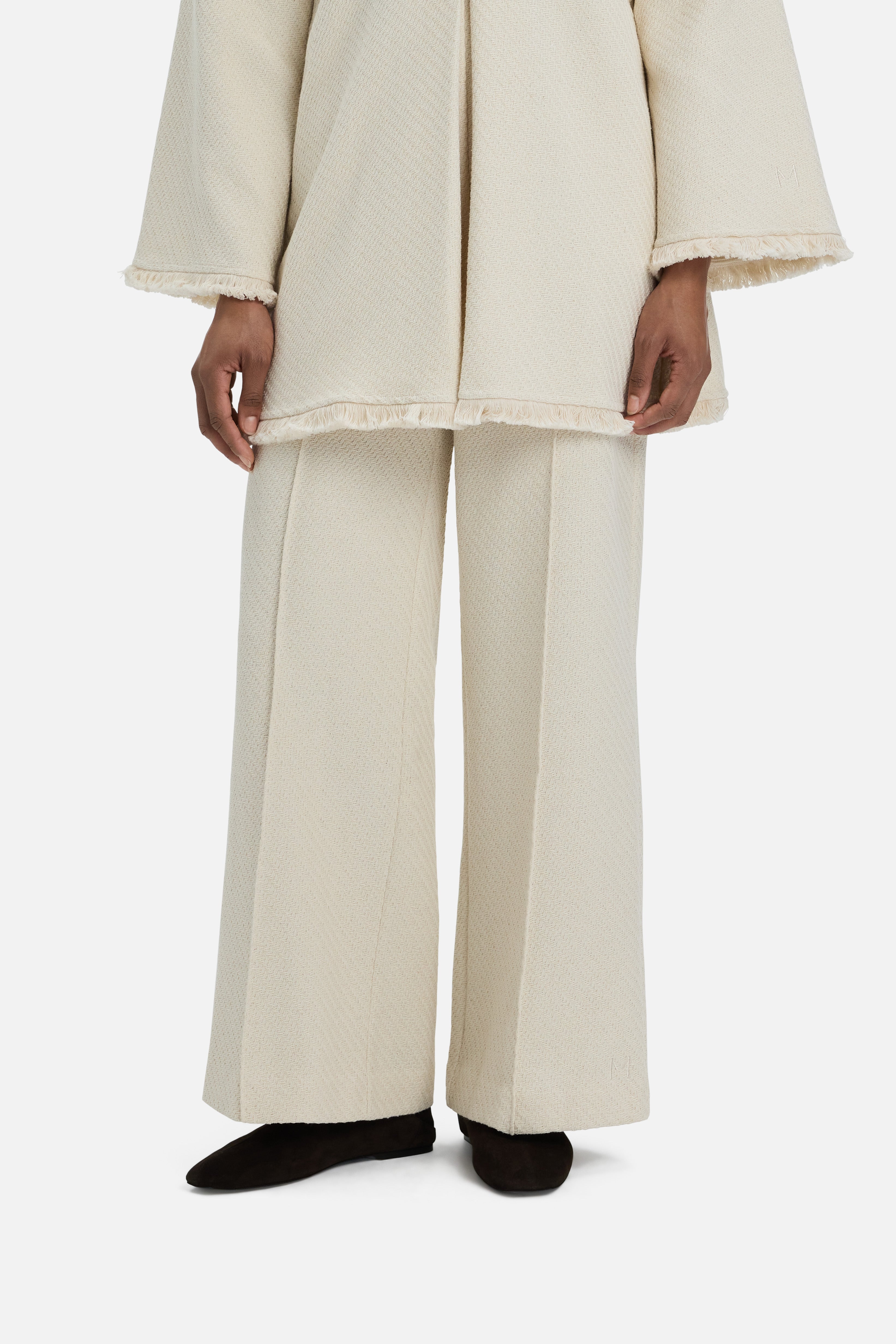 Cropped view model wearing white trousers