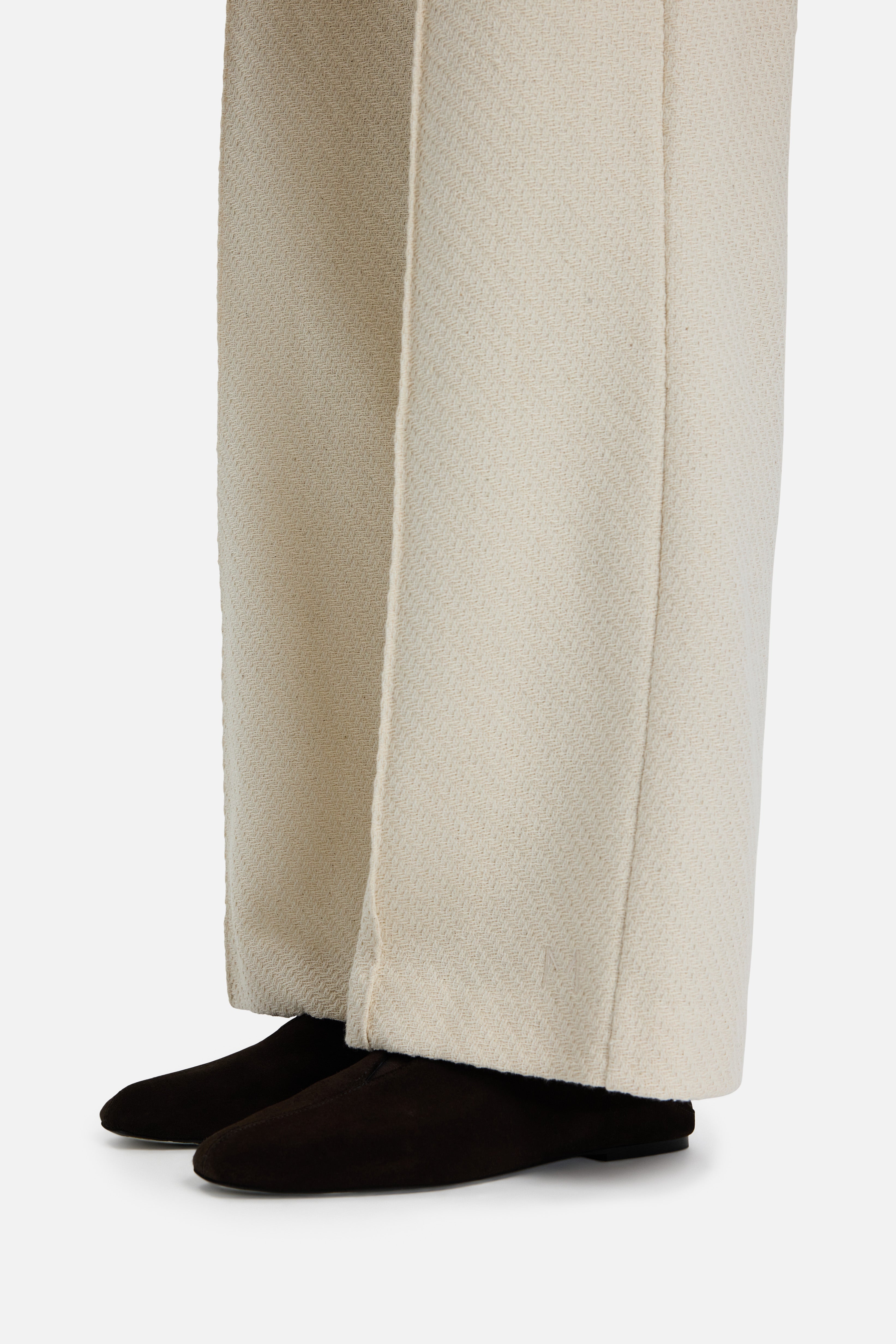 Detail view side off white trousers