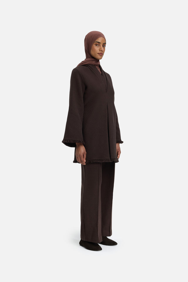 Front view model wearing dark brown top and headscarf