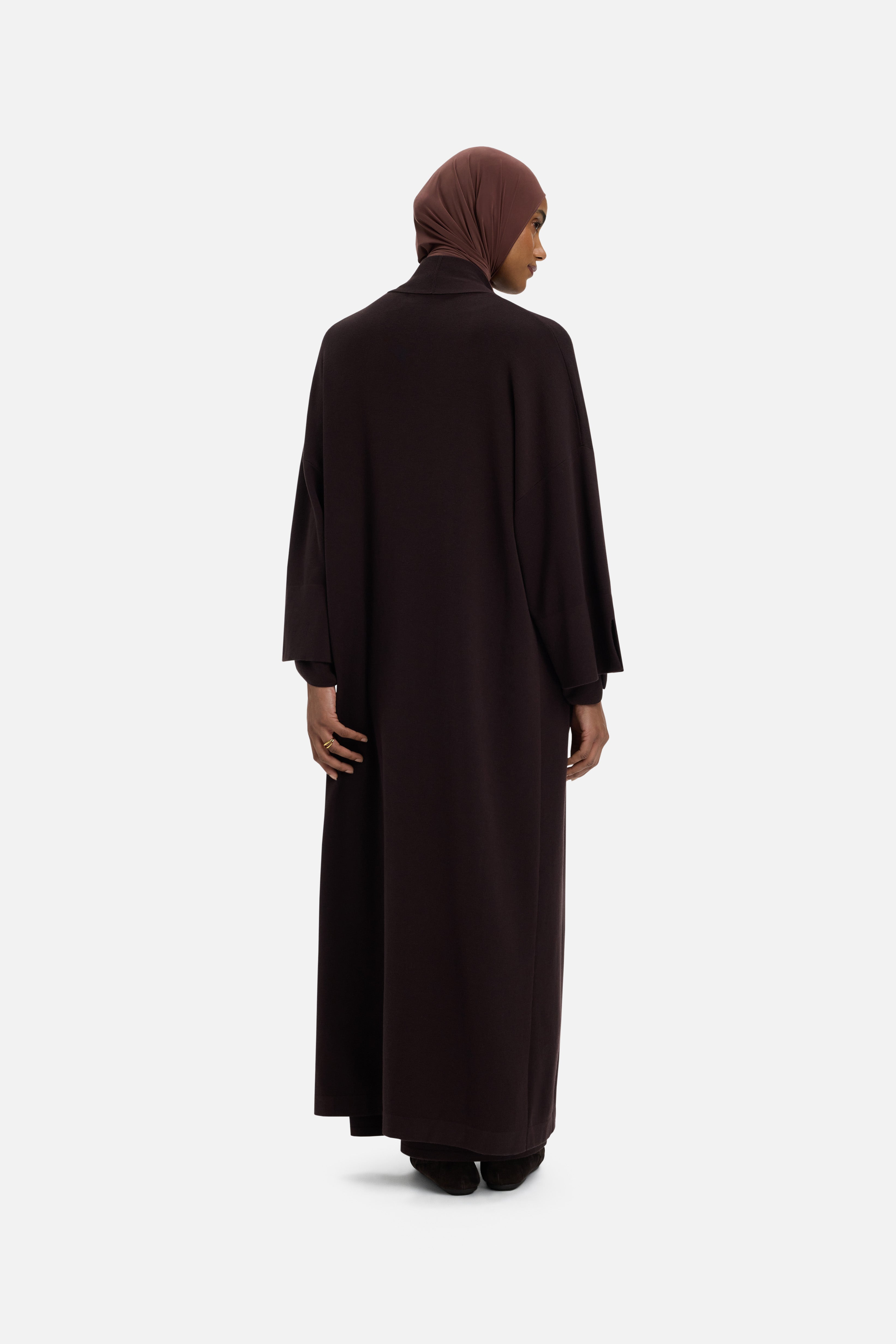 Back view model wearing brown abaya and headscarf