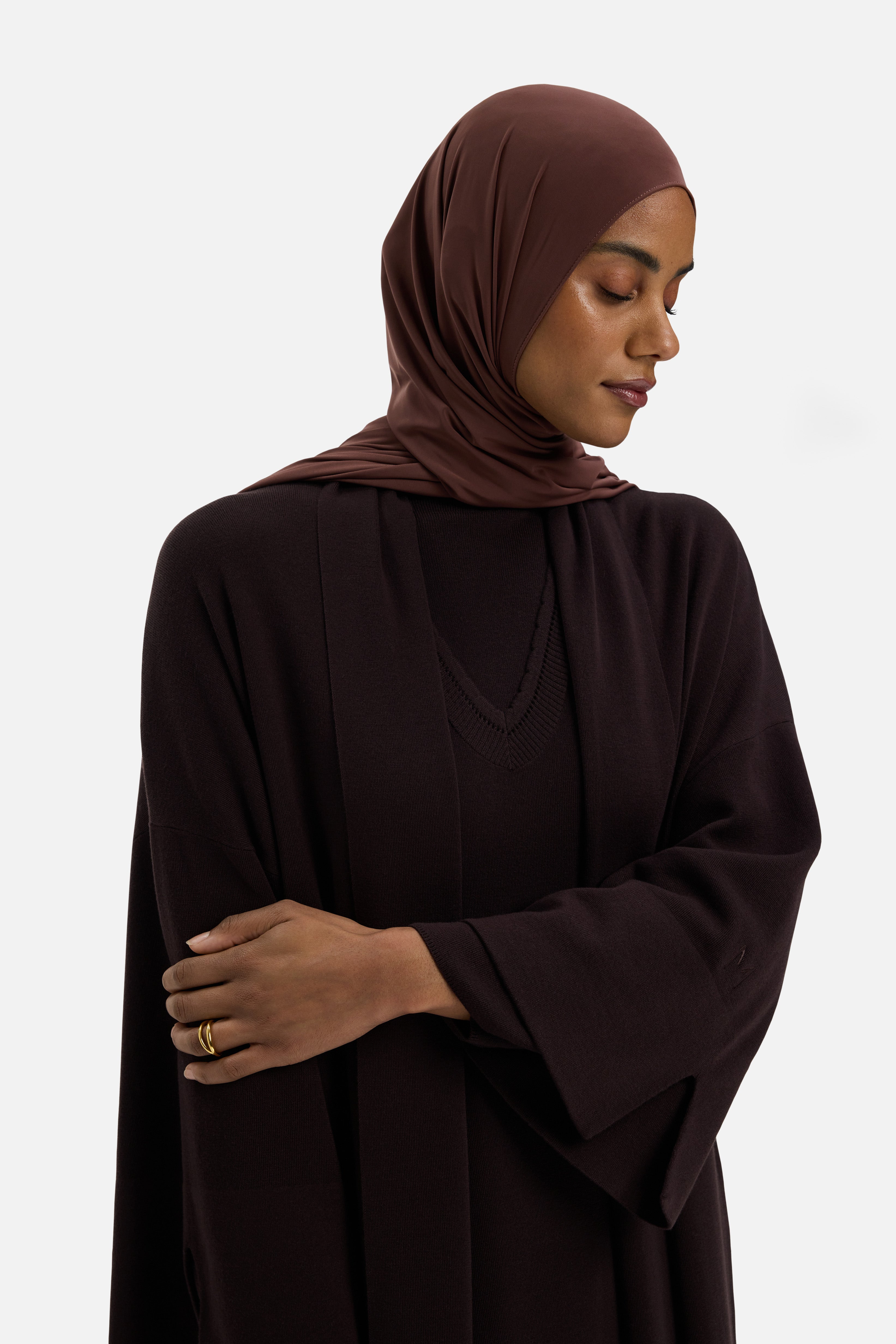 Close up model wearing brown abaya and headscarf