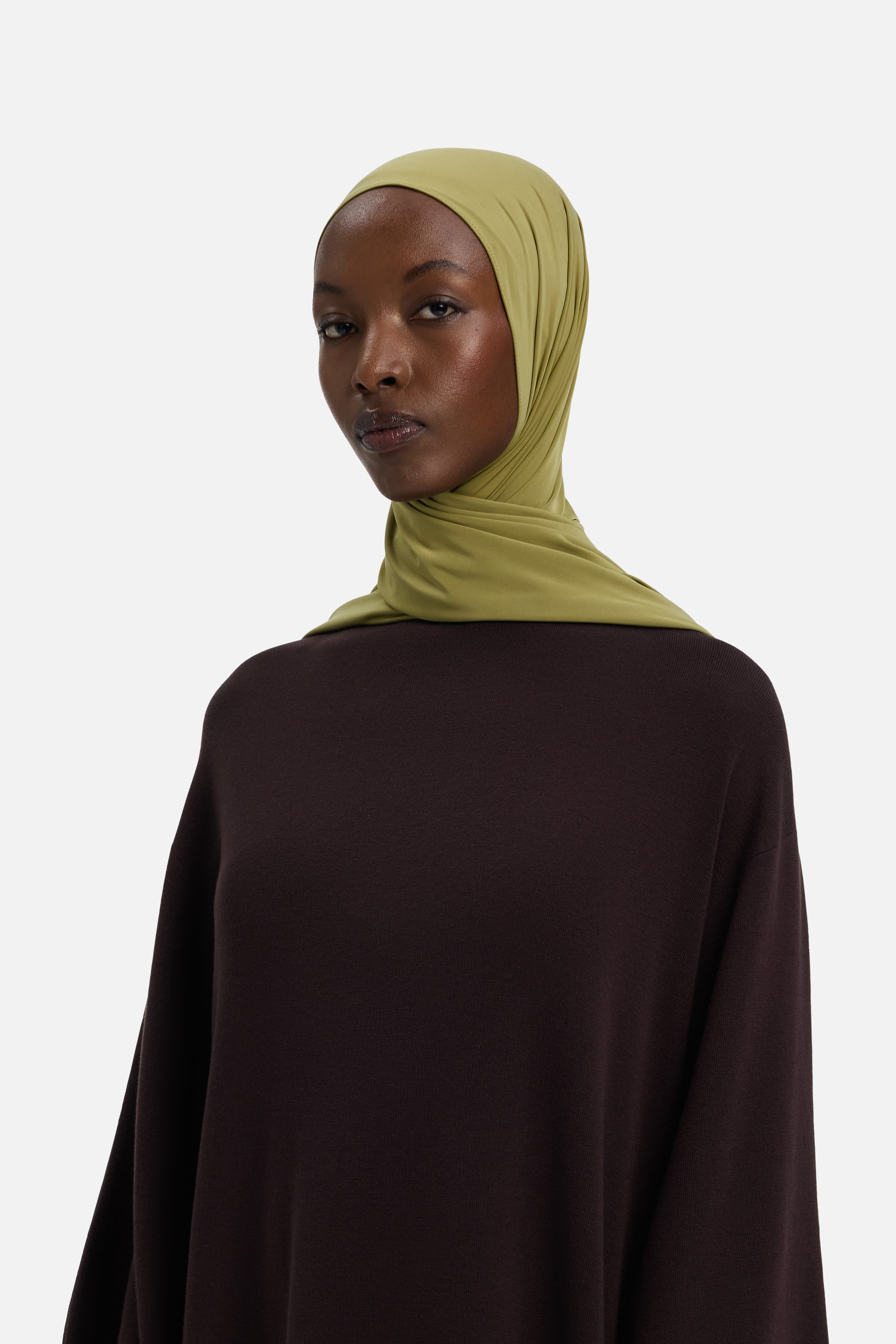 Model wearing green MERRACHI headscarf, side view