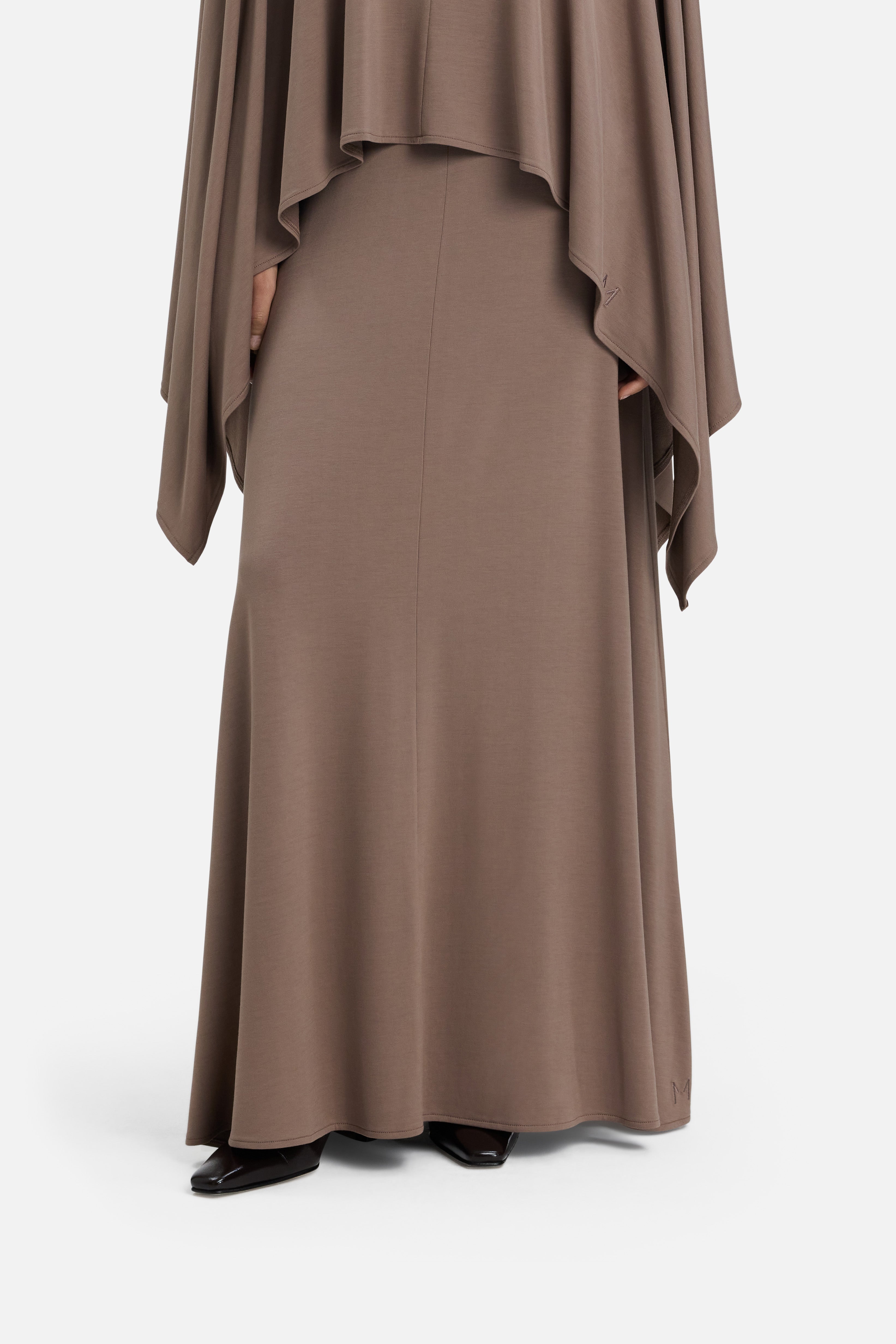 Cropped view model wearing taupe maxi skirt