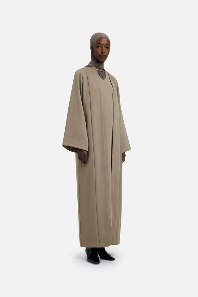 Front view model wearing khaki abaya and grey headscarf