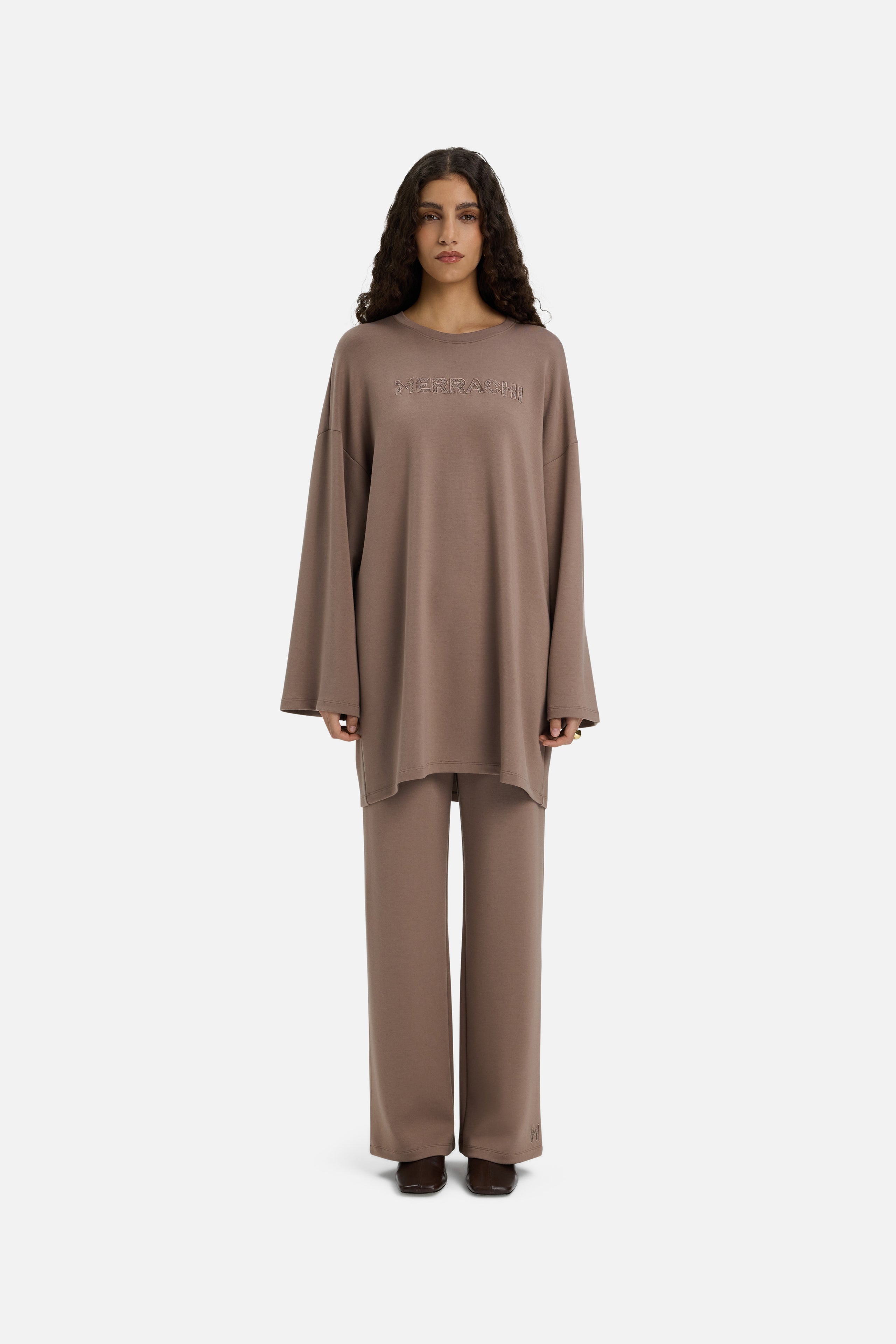 Model wearing taupe MERRACHI pants, front view